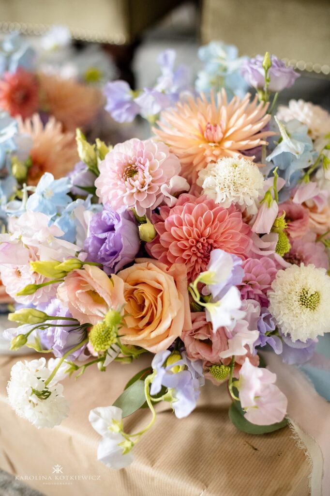 Close-up of pastel bridal bouquet with dahlias, roses, lisianthus, and sweet peas in peach, lilac, and soft blue, designed by Paperwhite Floral Design at Boturich Castle.
